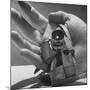 Micro Camera Resting in Palm of Hand-Andreas Feininger-Mounted Photographic Print