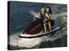 Mid Adult Couple Riding a Jet Ski-null-Stretched Canvas