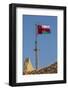 Middle East, Arabian Peninsula, Oman, Muscat, Muttrah. Omani flag flying in Muttrah.-Emily Wilson-Framed Photographic Print