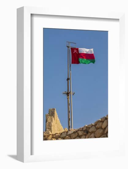 Middle East, Arabian Peninsula, Oman, Muscat, Muttrah. Omani flag flying in Muttrah.-Emily Wilson-Framed Photographic Print