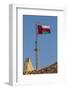 Middle East, Arabian Peninsula, Oman, Muscat, Muttrah. Omani flag flying in Muttrah.-Emily Wilson-Framed Photographic Print