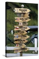 Mileage Sign Pointing Directions in Puerto Williams-Paul Souders-Stretched Canvas