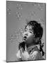 Mili's High Speed Camera Catches Little Girl Watching Shower of Soap Bubble Drifting Down on Her-Gjon Mili-Mounted Photographic Print