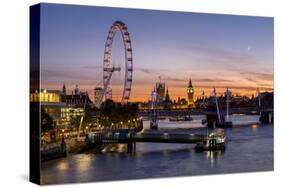 Millenium Wheel (London Eye) with Big Ben on the skyline beyond at sunset, London, England, United -Charles Bowman-Stretched Canvas