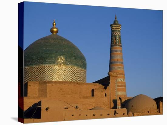 Minaret and Tiled Dome of a Mosque Rise Above the Old City of Khiva-Antonia Tozer-Stretched Canvas
