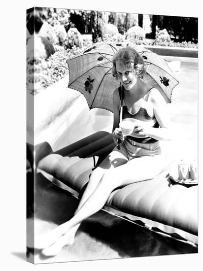 Minna Gombell, Sipping a Cup of Tea Poolside, 1931-null-Stretched Canvas