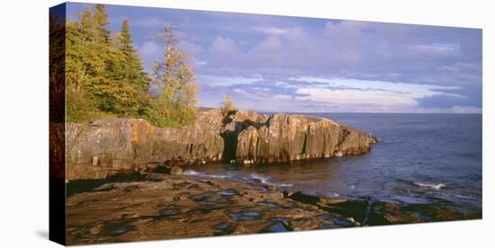 Minnesota, Lichen Covered Rocks and Stormy Sky over Lake Superior at Artist Point-John Barger-Stretched Canvas