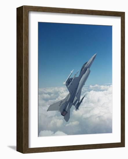 Missile-Armed Us F-16 Fighter Aircraft in Flight, Climbing Above Clouds-null-Framed Photographic Print