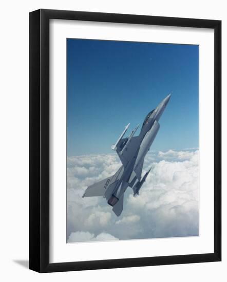 Missile-Armed Us F-16 Fighter Aircraft in Flight, Climbing Above Clouds-null-Framed Photographic Print