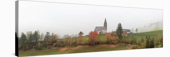 Mist and colourful trees surround the alpine church in the fall, St. Magdalena, Funes Valley, South-Roberto Moiola-Stretched Canvas