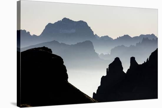 Mist on peaks of Dolomites and Monte Pelmo seen from Cima Belvedere at dawn, Val di Fassa, Trentino-Roberto Moiola-Stretched Canvas