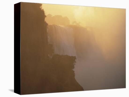 Mist Over Victoria Falls at Sunrise, Zimbabwe-Jim Zuckerman-Stretched Canvas