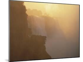 Mist Over Victoria Falls at Sunrise, Zimbabwe-Jim Zuckerman-Mounted Photographic Print