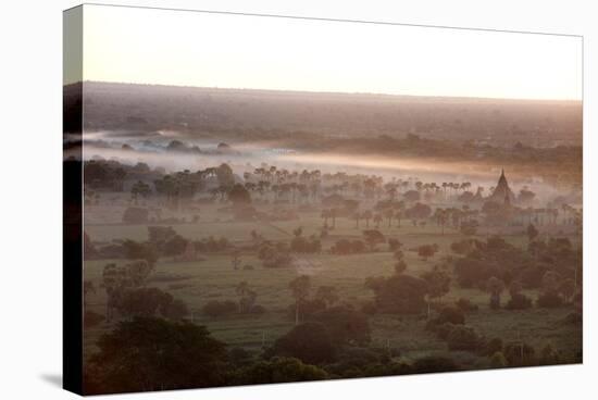 Mists from the Nearby Irrawaddy River Floating across Bagan (Pagan), Myanmar (Burma)-Annie Owen-Stretched Canvas