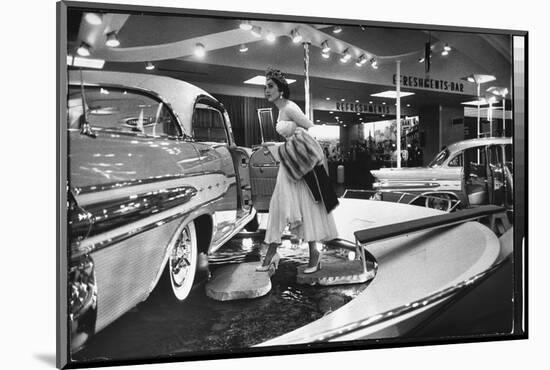 Model Gingerly Traversing Stepping Stones to Get to La Parisienne Pontiac Hard Top Car on Display-Walter Sanders-Mounted Photographic Print