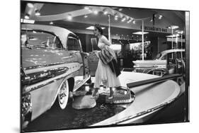 Model Gingerly Traversing Stepping Stones to Get to La Parisienne Pontiac Hard Top Car on Display-Walter Sanders-Mounted Premium Photographic Print