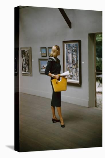 Model in a David Goodstein-Designed Outfit, Looks at Paintings in a Museum, New York, 1954-Nina Leen-Stretched Canvas