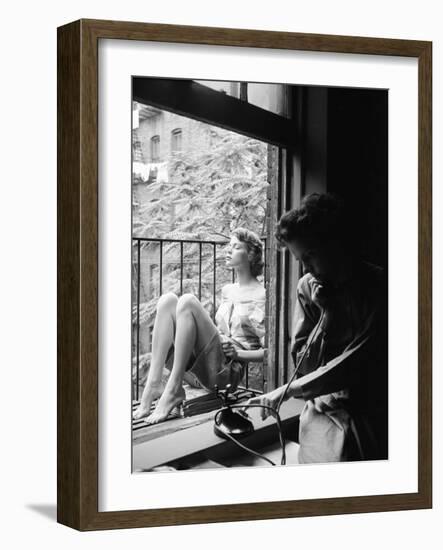 Model Jean Patchet Seated on a Fire Escape, Talks with Eileen Ford, New York, NY, 1948-Nina Leen-Framed Photographic Print