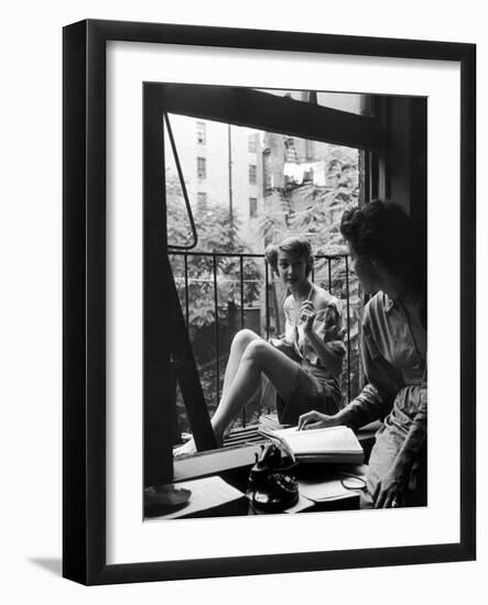 Model Jean Patchet Seated on a Fire Escape, Talks with Eileen Ford, New York, NY, 1948-Nina Leen-Framed Photographic Print