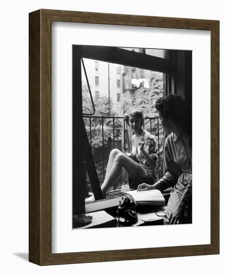 Model Jean Patchet Seated on a Fire Escape, Talks with Eileen Ford, New York, NY, 1948-Nina Leen-Framed Photographic Print