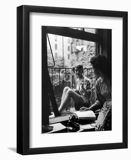 Model Jean Patchet Seated on a Fire Escape, Talks with Eileen Ford, New York, NY, 1948-Nina Leen-Framed Premium Photographic Print