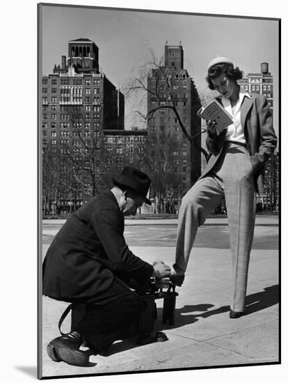 Model Showing Off Slacks as She Reads a First Aid Text Book in Washington Square Park-Nina Leen-Mounted Photographic Print