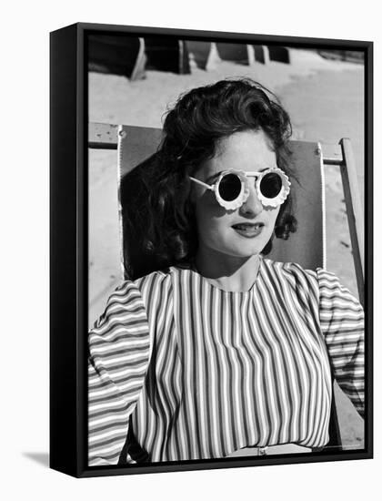 Model Stephanie Nikashian Sporting Sunglasses with "Seashell Rims" While Lounging at Beach-Alfred Eisenstaedt-Framed Stretched Canvas