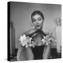 Model Wearing a Flowery Glove While Peering Into the Distance-Nina Leen-Stretched Canvas