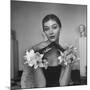 Model Wearing a Flowery Glove While Peering Into the Distance-Nina Leen-Mounted Photographic Print