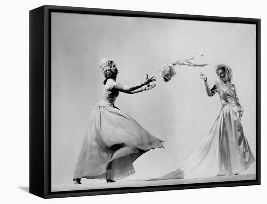 Model Wearing Wedding Gown Tossing Bouquet to Another Model Dresses as Bridesmaid-Gjon Mili-Framed Stretched Canvas