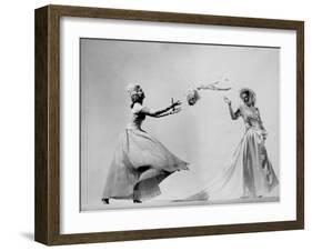 Model Wearing Wedding Gown Tossing Bouquet to Another Model Dresses as Bridesmaid-Gjon Mili-Framed Photographic Print