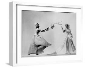 Model Wearing Wedding Gown Tossing Bouquet to Another Model Dresses as Bridesmaid-Gjon Mili-Framed Photographic Print