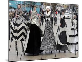 Models on Stilts Present "High Fashion" on the Famous "Jungfernstieg" Boulevard in Hamburg, Germany-null-Mounted Photographic Print