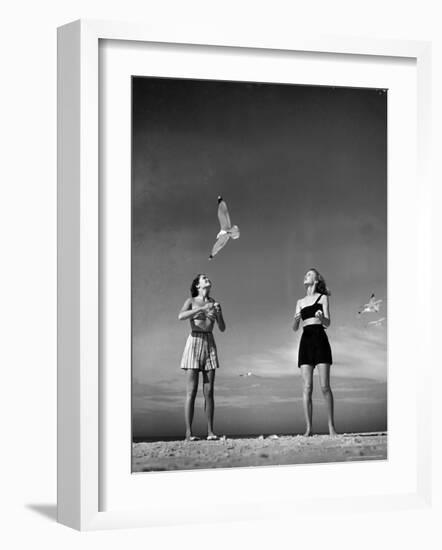 Models Tee Matthews and Bobbie Chambliss Feeding Gulls While Modeling New Bathing Suit Styles-Alfred Eisenstaedt-Framed Photographic Print