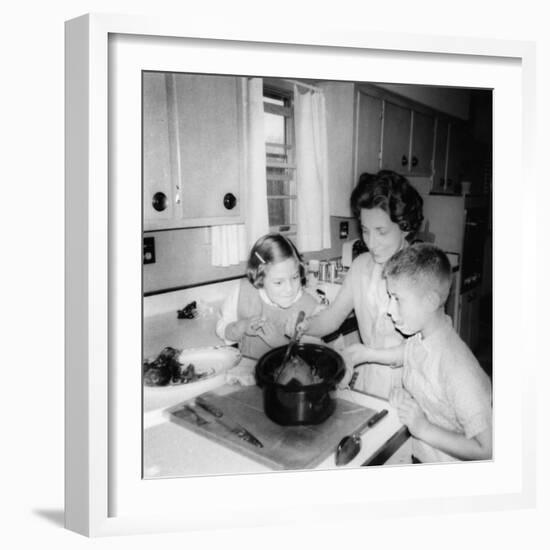 Mom Prepares Dinner with the Kids Watching, Ca. 1962-null-Framed Photographic Print