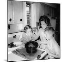 Mom Prepares Dinner with the Kids Watching, Ca. 1962-null-Mounted Photographic Print