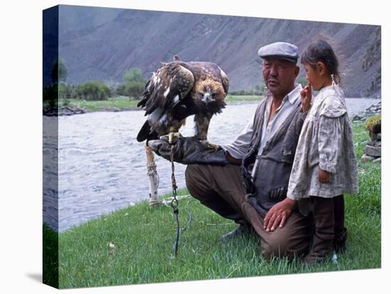 Mongolia, Kasakh Hunter with Eagle by the Khovd River, with a Small Child-Antonia Tozer-Stretched Canvas