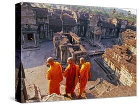 Monks Overlook Angkor Wat, Cambodia-Tom Haseltine-Stretched Canvas