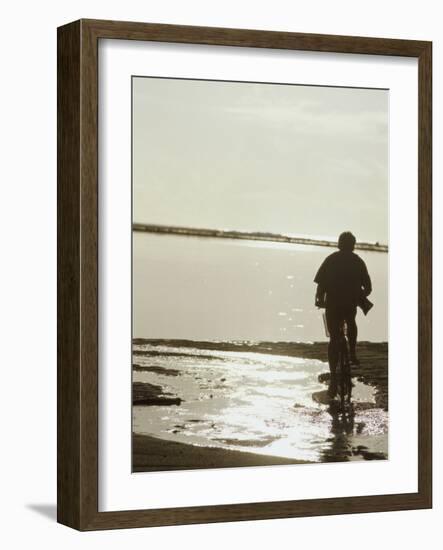 Monochromatic Image of a Cyclist on the Beach-null-Framed Photographic Print