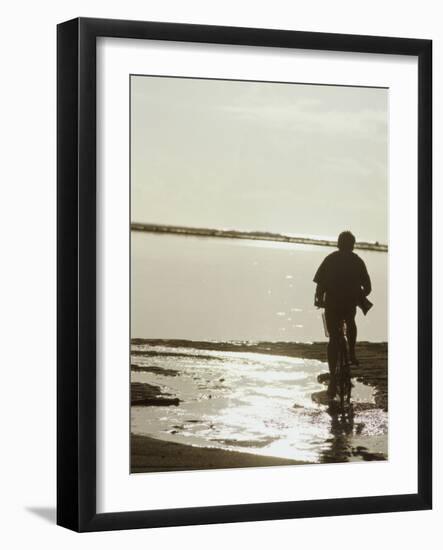 Monochromatic Image of a Cyclist on the Beach-null-Framed Photographic Print