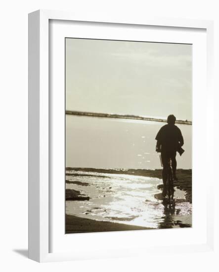 Monochromatic Image of a Cyclist on the Beach-null-Framed Photographic Print