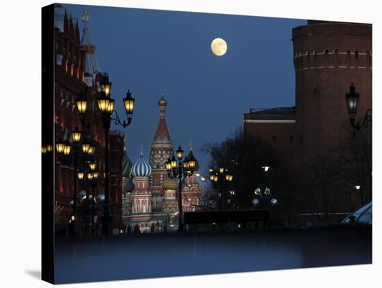 Moon is Seen over the Red Square in Moscow with the St. Basil Cathedral in the Background-null-Stretched Canvas