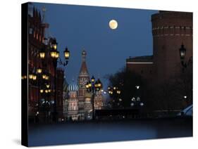 Moon is Seen over the Red Square in Moscow with the St. Basil Cathedral in the Background-null-Stretched Canvas