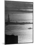 Moonlight on the Waters Surrounding Statue of Liberty as a Tug Boat Steams Past in New York Harbor-Andreas Feininger-Mounted Photographic Print