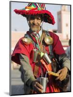 Moroccan Water Seller in Traditional Dress in the Djemaa El Fna, Marrakech-Julian Love-Mounted Photographic Print