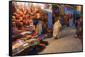 Morocco. An elderly man walks past tourist shops along a street in the blue city of Chefchaouen.-Brenda Tharp-Framed Stretched Canvas