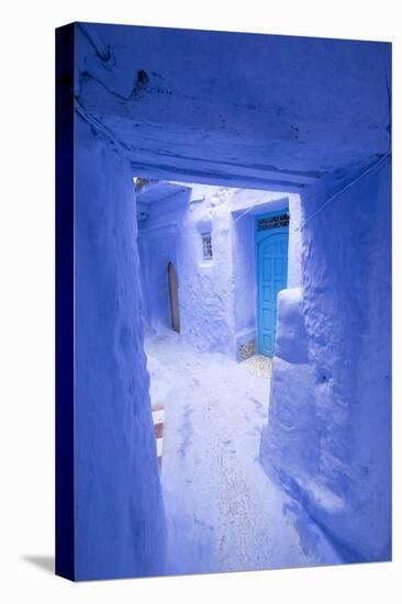 Morocco, Chaouen. Narrow Street Lined with Blue Buildings-Emily Wilson-Stretched Canvas