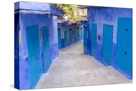 Morocco, Chaouen. Narrow Street Lined with Blue Buildings-Emily Wilson-Stretched Canvas