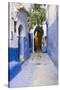 Morocco, Chaouen. Narrow Street Lined with Blue Buildings-Emily Wilson-Stretched Canvas