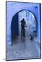 Morocco, Chefchaouen. Bicyclist Rides Past Cat in Archway in the Blue Village of Chefchaouen-Brenda Tharp-Mounted Photographic Print